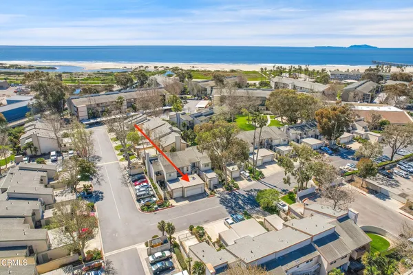 a aerial view of a house with a yard and potted plants