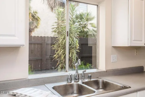 a kitchen with a sink and a large window