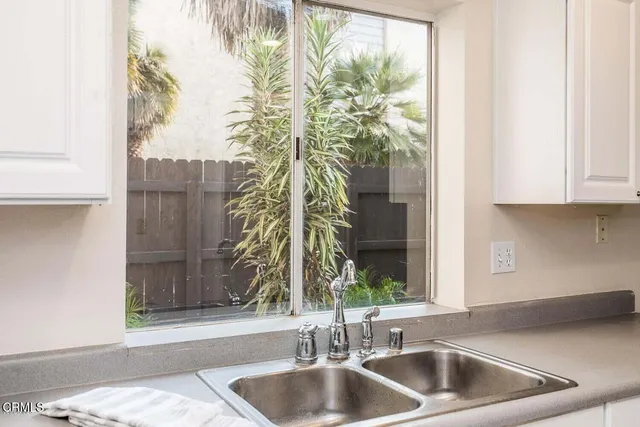 a kitchen with a sink and a large window