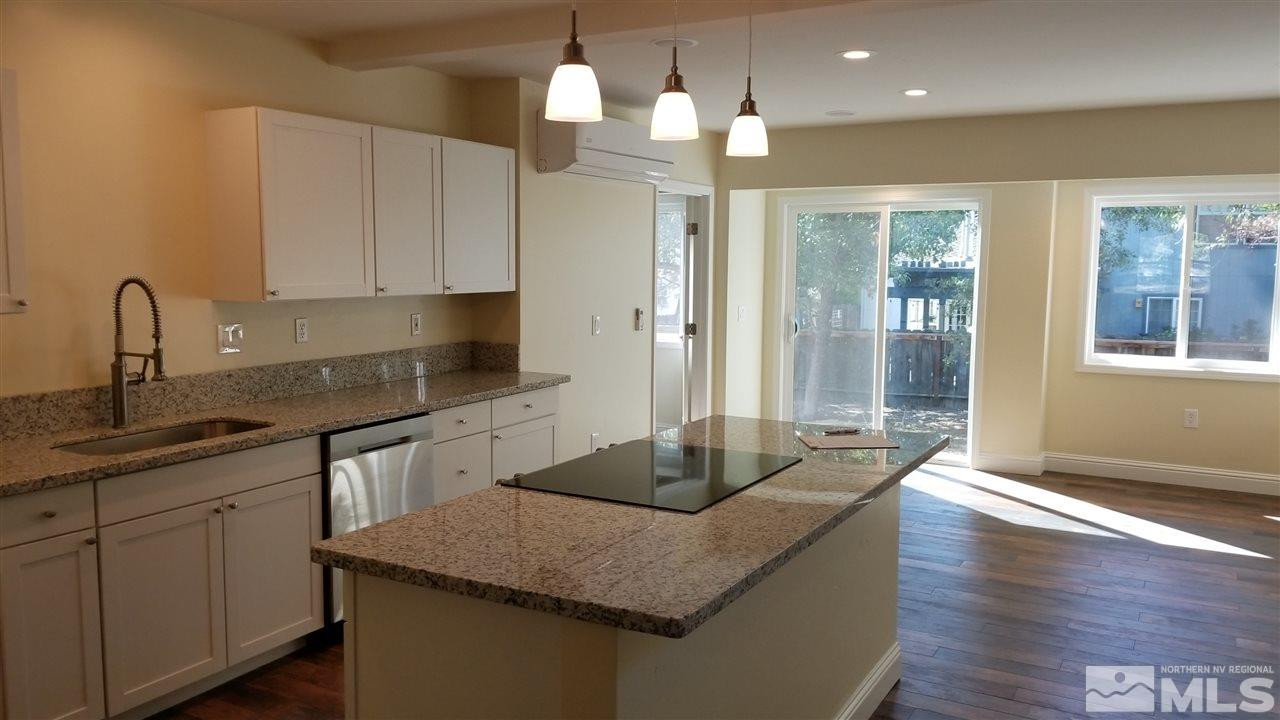812 Gear Street Reno, NV 89503 - Photo 2 of 21 a kitchen with granite countertop a sink cabinets and wooden floor