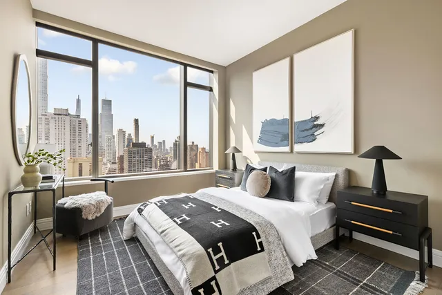 a bedroom with a bed and a couch next to a window