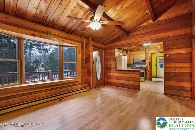 a empty room with wooden floor and windows