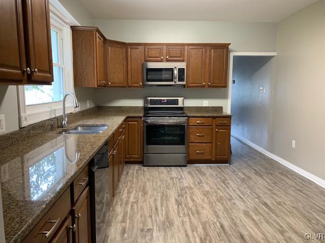112 A Street Bangor, PA 18013 - Photo 3 of 6 a kitchen with granite countertop a stove a sink and a microwave