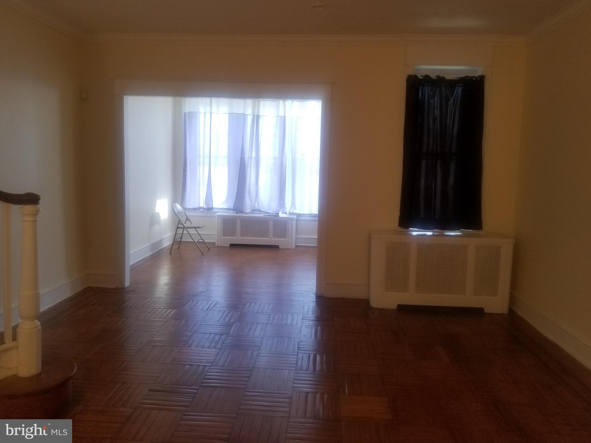 226 Copley Road Upper Darby, PA 19082 - Photo 2 of 10 an empty room with wooden floor and windows