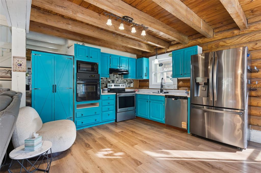 1208 D Arcy Road Lady Lake, FL 32159 - Photo 14 of 50 a kitchen with stainless steel appliances kitchen island granite countertop a refrigerator a stove top oven a sink and dishwasher