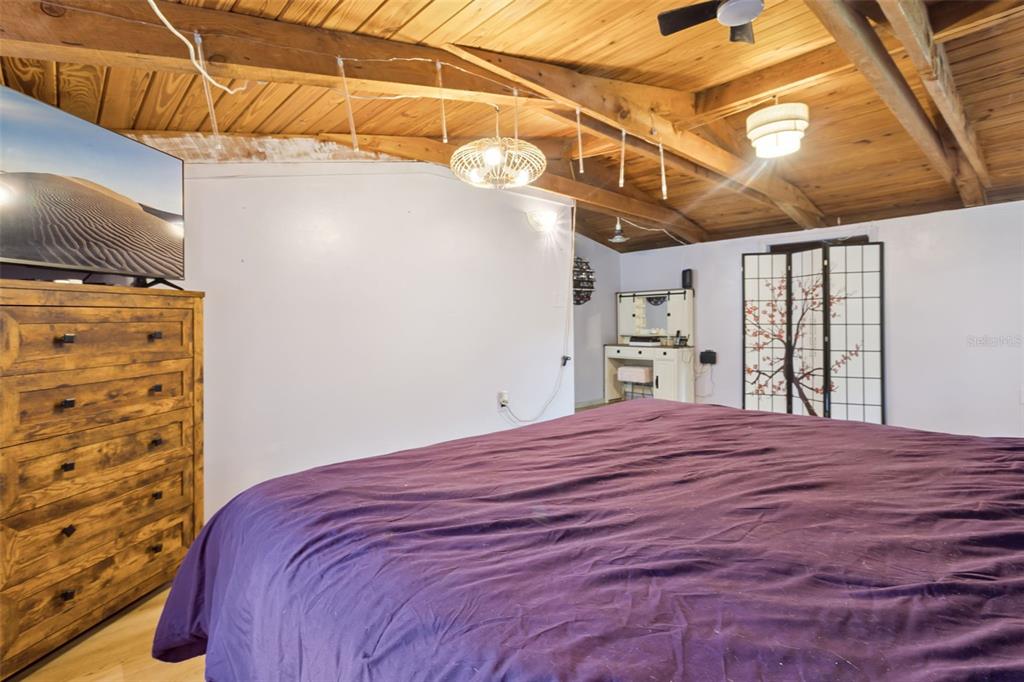 1208 D Arcy Road Lady Lake, FL 32159 - Photo 18 of 50 a bedroom with a bed and a flat tv screen on the dresser