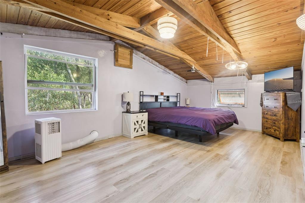1208 D Arcy Road Lady Lake, FL 32159 - Photo 19 of 50 a view of a big room with wooden floor and furniture