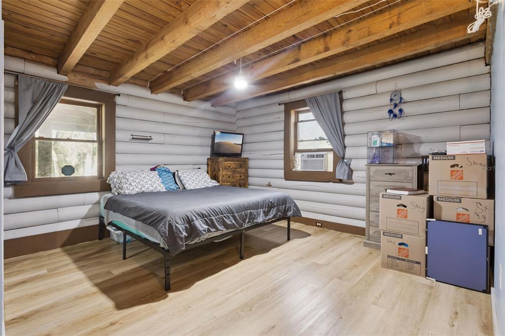 1208 D Arcy Road Lady Lake, FL 32159 - Photo 23 of 50 a spacious bedroom with a bed and wooden floor