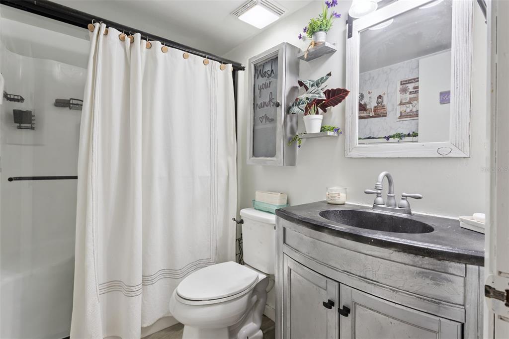 1208 D Arcy Road Lady Lake, FL 32159 - Photo 25 of 50 a bathroom with a sink a toilet and a mirror