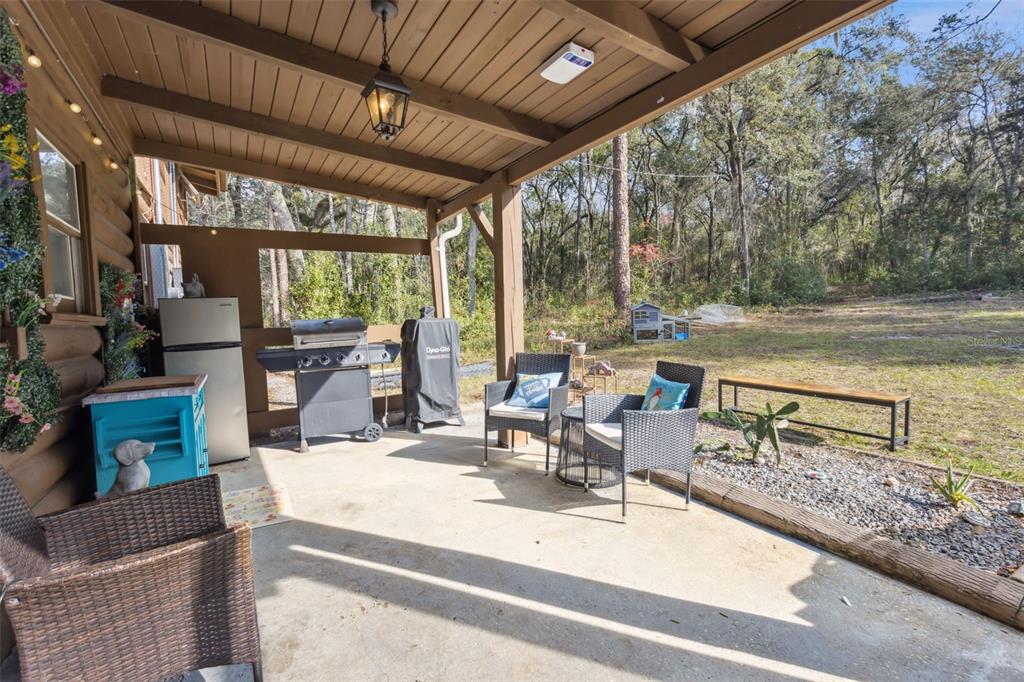 1208 D Arcy Road Lady Lake, FL 32159 - Photo 26 of 50 a view of living room kitchen with furniture and floor to ceiling window