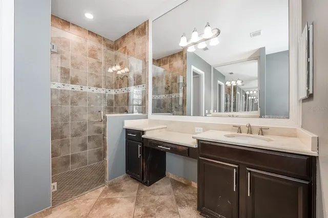 a bathroom with a sink a mirror and a shower