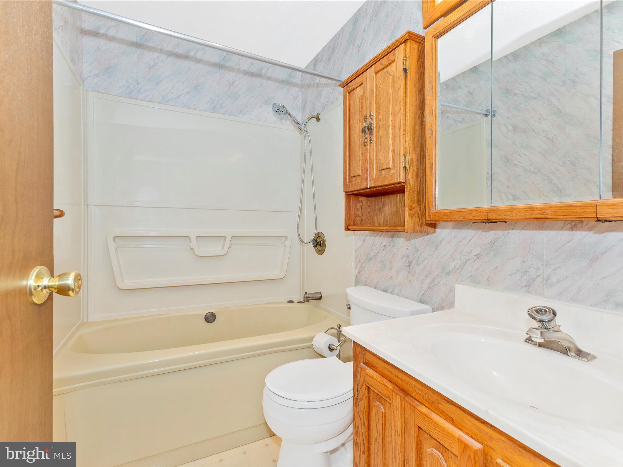 8344 Capel Drive Pasadena, MD 21122 - Photo 20 of 30 a bathroom with a sink a toilet and a bathtub