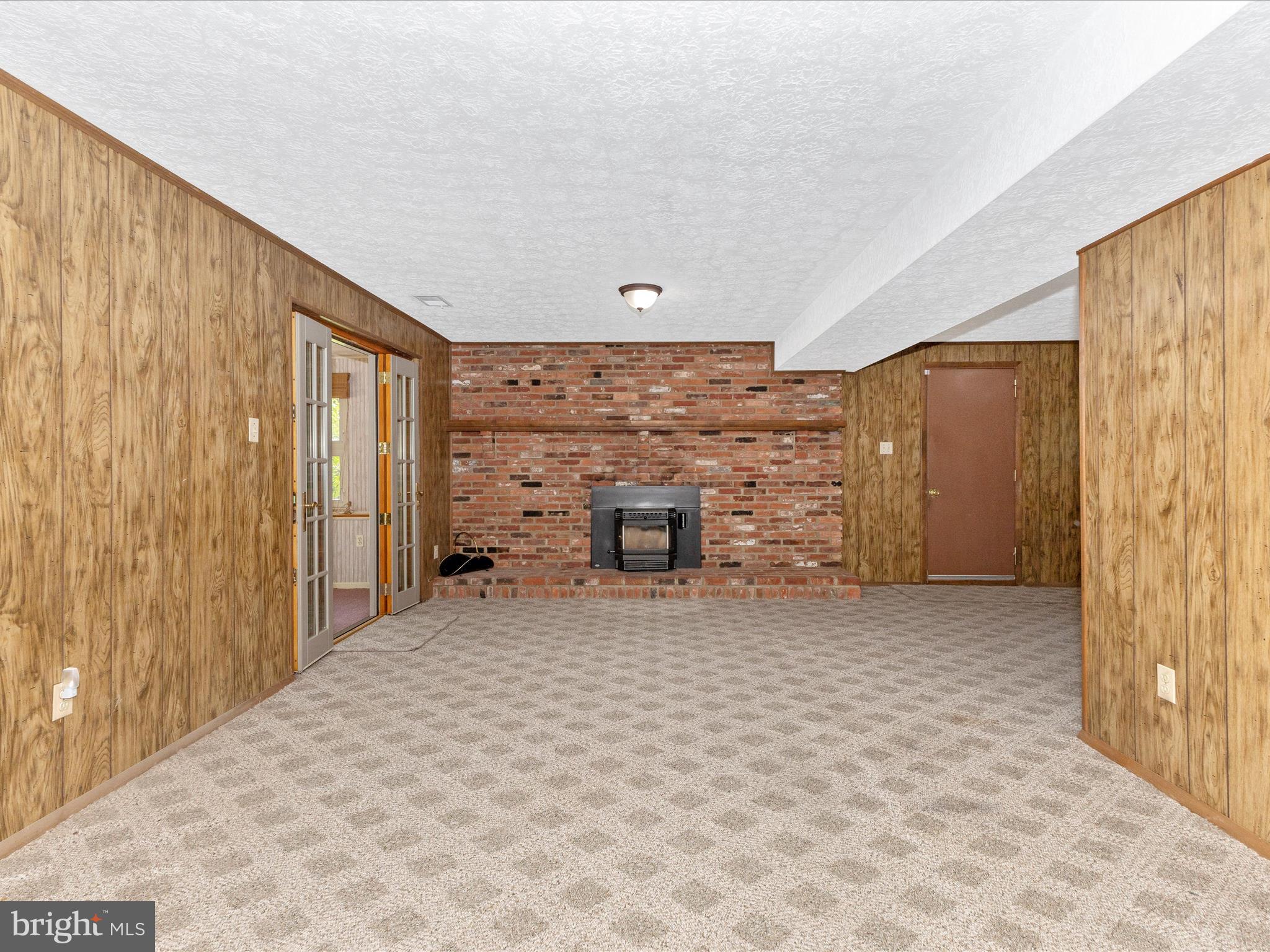 8344 Capel Drive Pasadena, MD 21122 - Photo 21 of 30 a view of an empty room with a fireplace