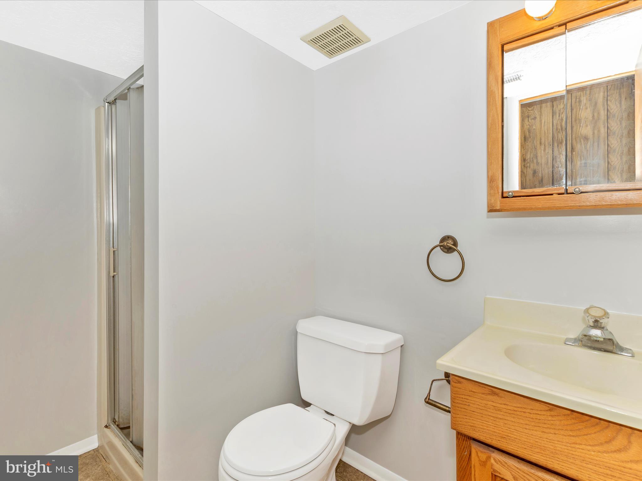 8344 Capel Drive Pasadena, MD 21122 - Photo 25 of 30 a bathroom with a sink a toilet and a window