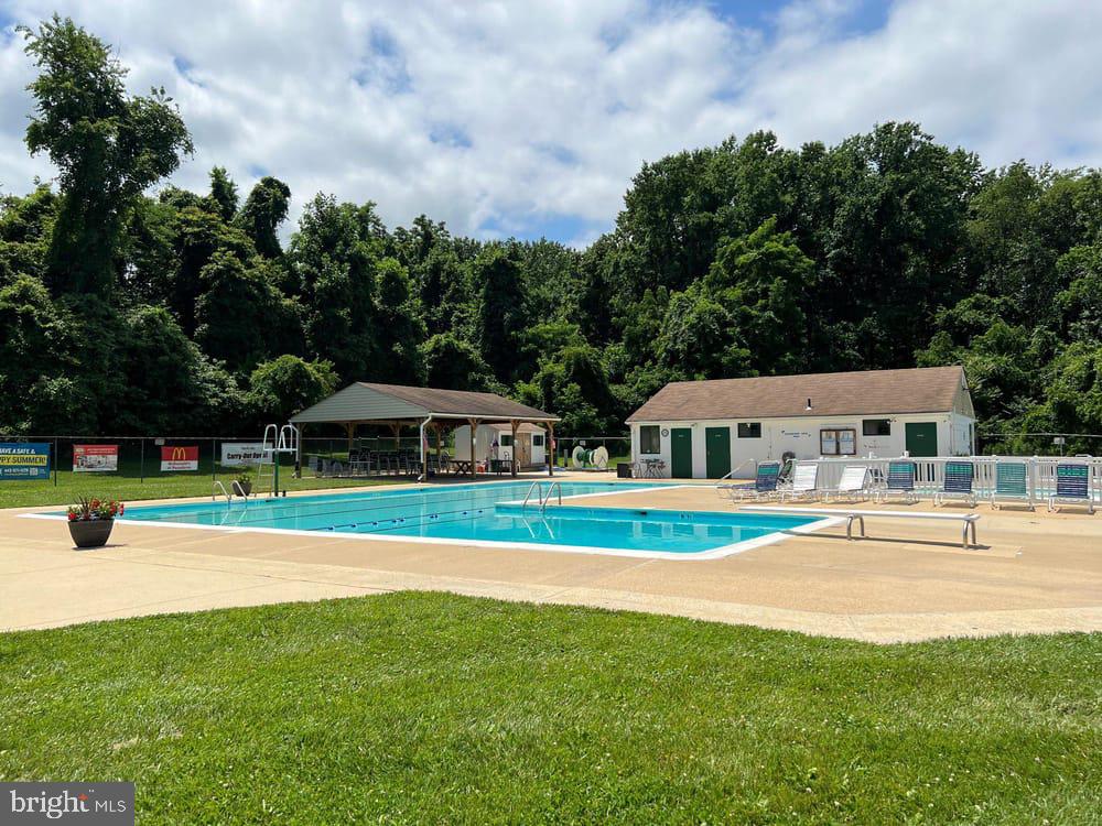 8344 Capel Drive Pasadena, MD 21122 - Photo 26 of 30 a view of a house with a big yard and large trees
