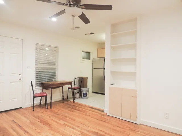 a workspace room with furniture and wooden floor