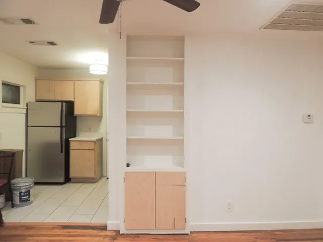 a view of a kitchen with refrigerator and microwave
