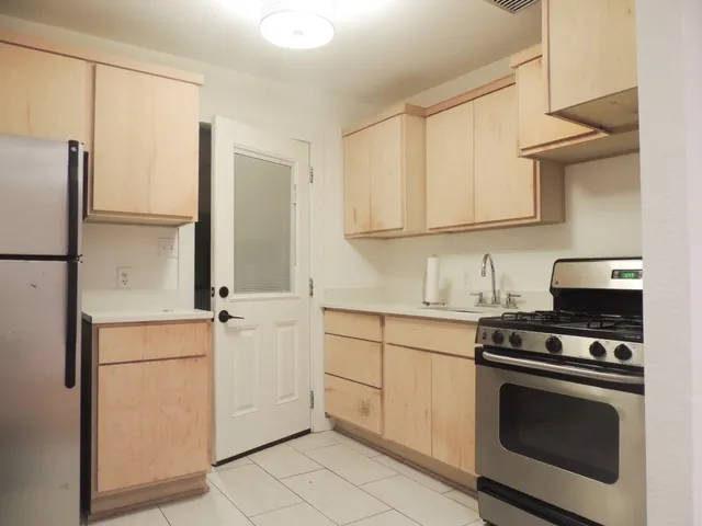 a kitchen with cabinets and appliances