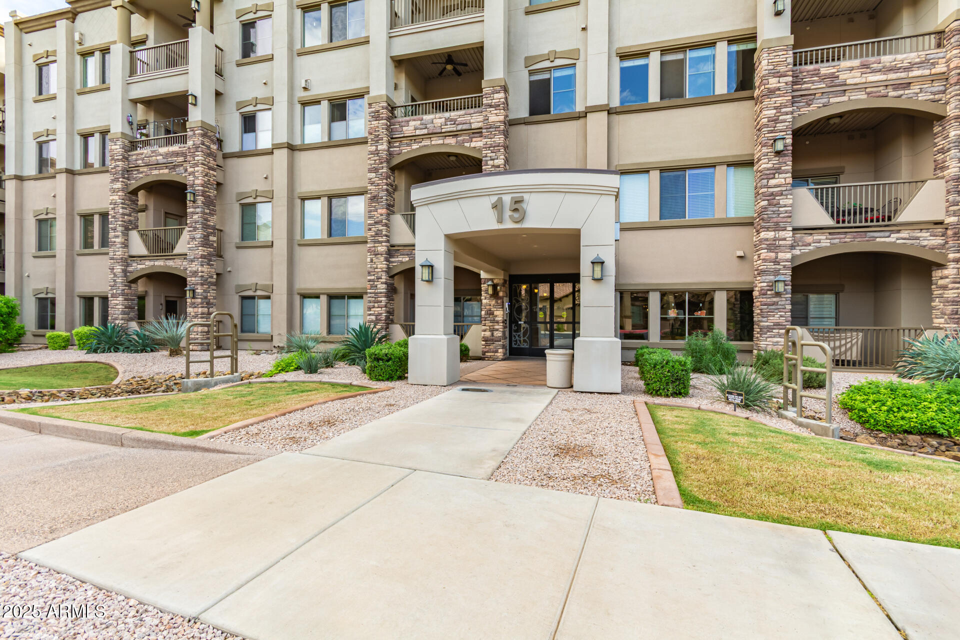 5350 East Deer Valley Drive, Unit 1259 Phoenix, AZ 85054 - Photo 1 of 35 a front view of a building with a garden