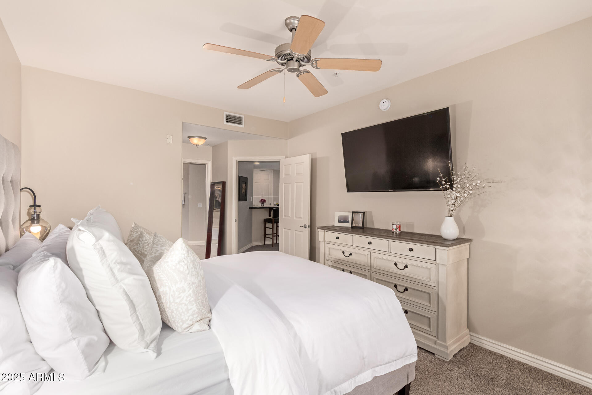 5350 East Deer Valley Drive, Unit 1259 Phoenix, AZ 85054 - Photo 11 of 35 a spacious bedroom with a bed and a flat screen tv