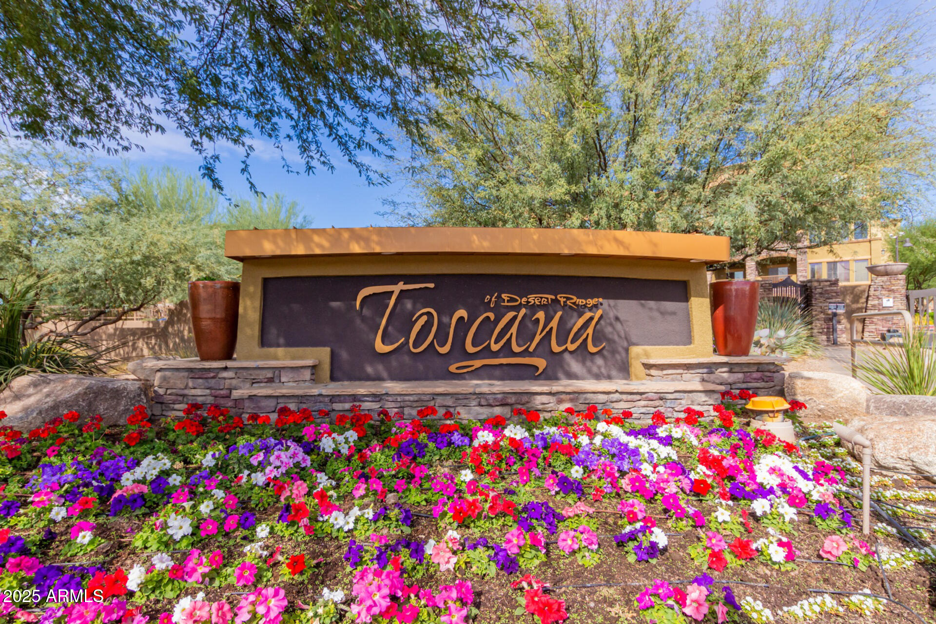 5350 East Deer Valley Drive, Unit 1259 Phoenix, AZ 85054 - Photo 34 of 35 a street sign that is sitting in front of flowers