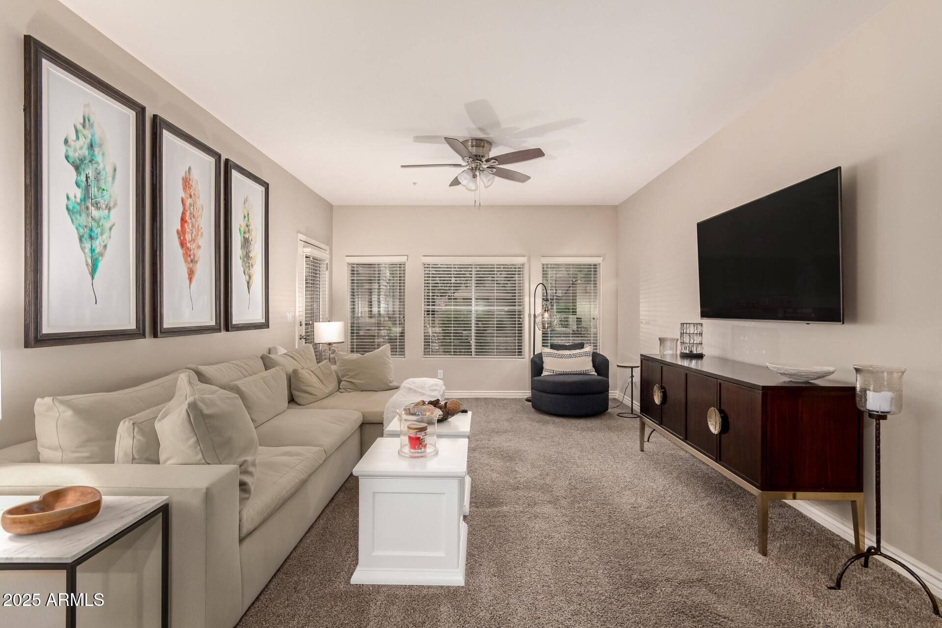 5350 East Deer Valley Drive, Unit 1259 Phoenix, AZ 85054 - Photo 4 of 35 a living room with furniture and a flat screen tv