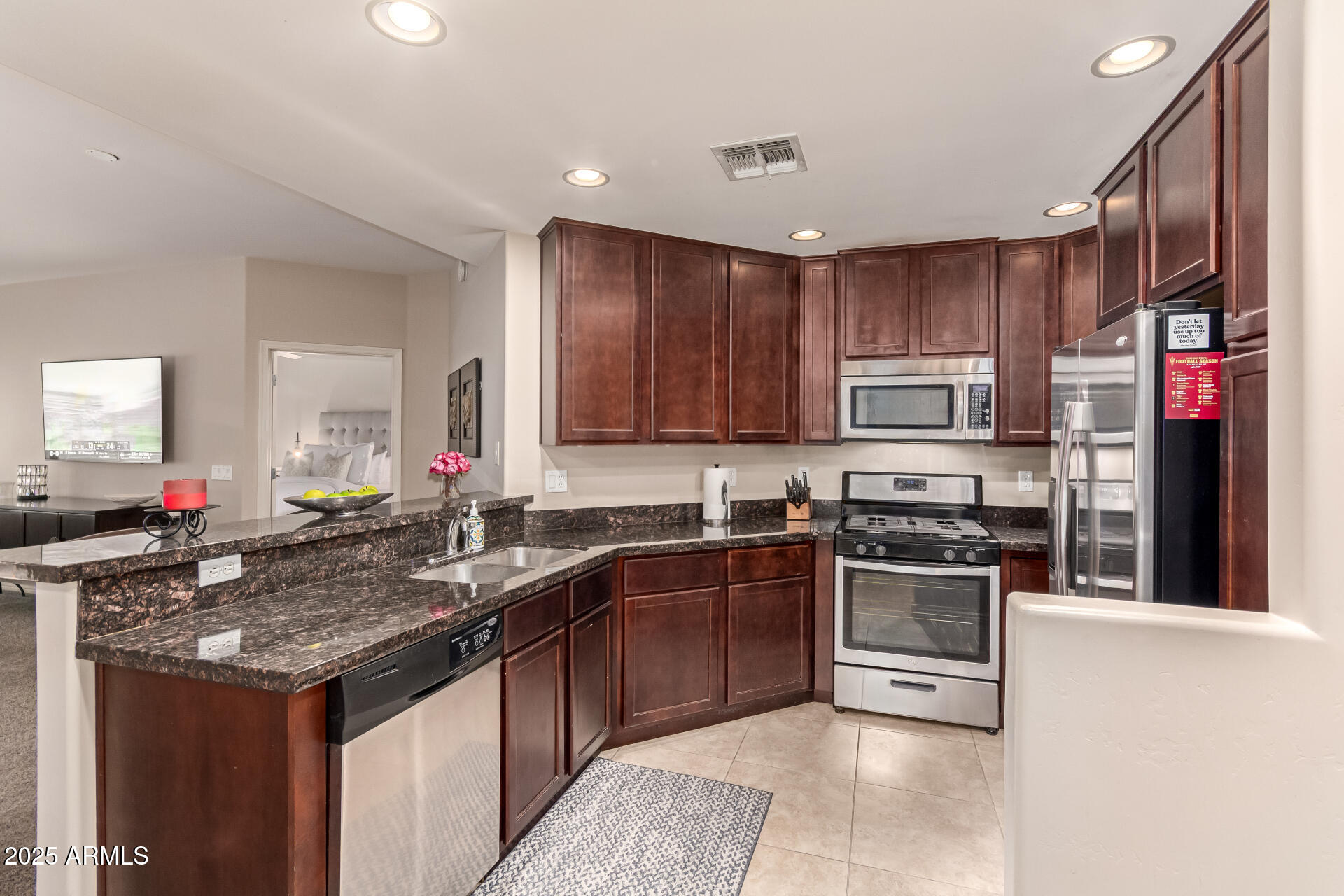 5350 East Deer Valley Drive, Unit 1259 Phoenix, AZ 85054 - Photo 5 of 35 a kitchen with stainless steel appliances granite countertop a sink stove and refrigerator