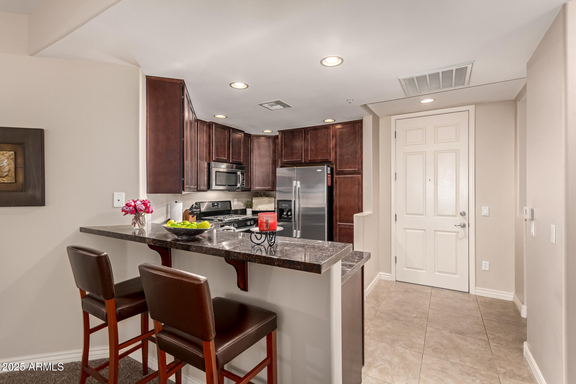 5350 East Deer Valley Drive, Unit 1259 Phoenix, AZ 85054 - Photo 6 of 35 a kitchen that has a cabinets counter space and appliances