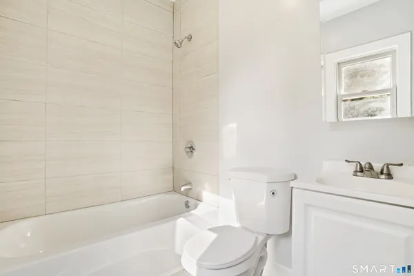 a bathroom with a toilet a sink and bathtub