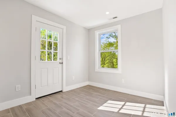 wooden floor in an empty room with a window