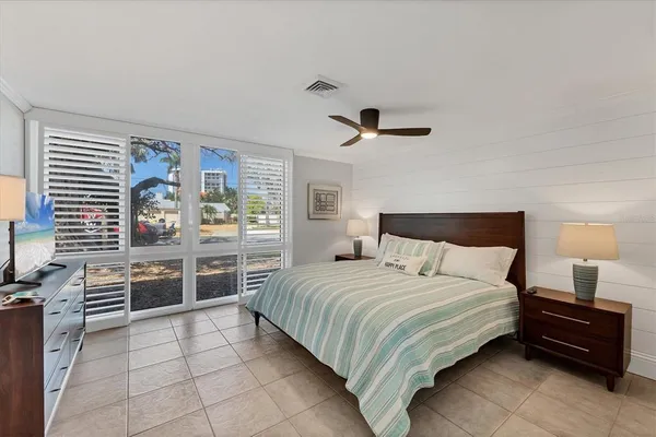 a bedroom with a large bed and a window