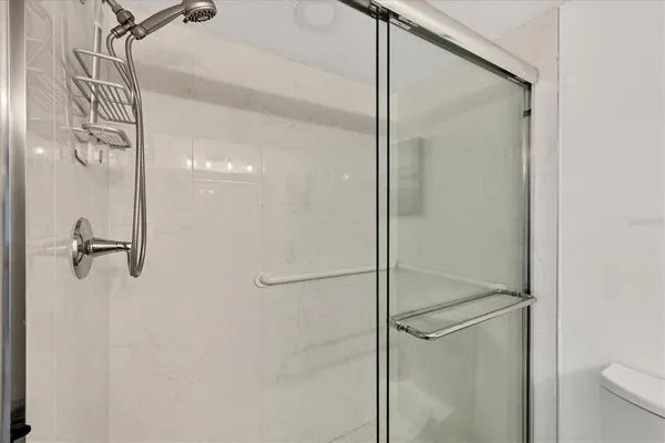 a bathroom with a glass shower door