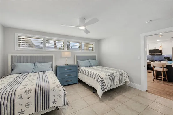 a bedroom with two beds and painting on the wall