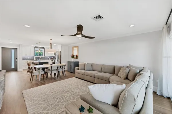 a living room with furniture and a dining table