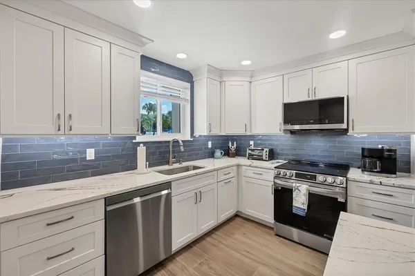 a kitchen with a sink stove and microwave