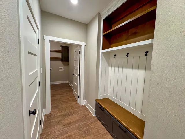 a view of a room with wooden floor and entryway