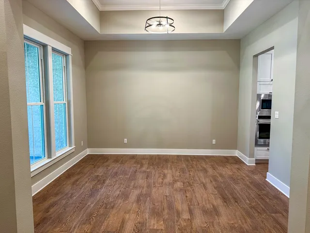 an empty room with wooden floor and closet
