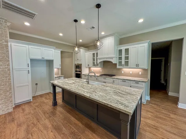 a kitchen with center island and a wooden floor