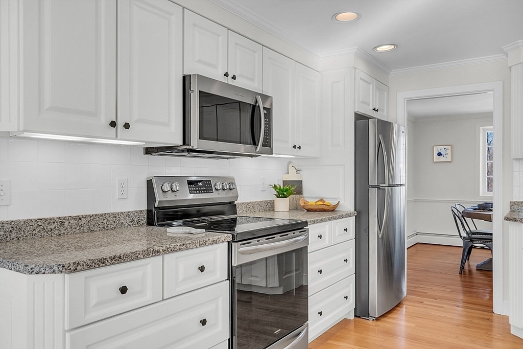 114 Bailey Road Andover, MA 01810 - Photo 11 of 42 a kitchen with granite countertop white cabinets and stainless steel appliances