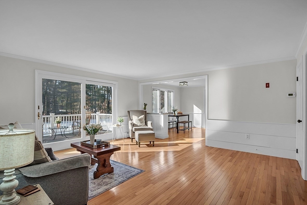 114 Bailey Road Andover, MA 01810 - Photo 14 of 42 a living room with fireplace furniture and a wooden floor