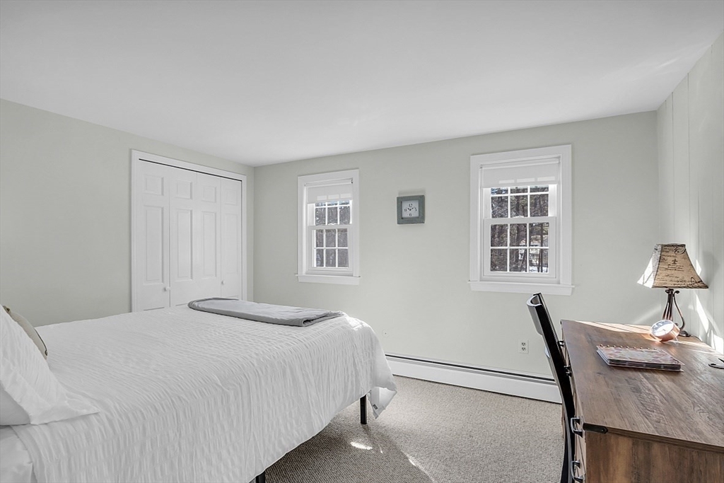 114 Bailey Road Andover, MA 01810 - Photo 27 of 42 a bedroom with a bed and a table in it