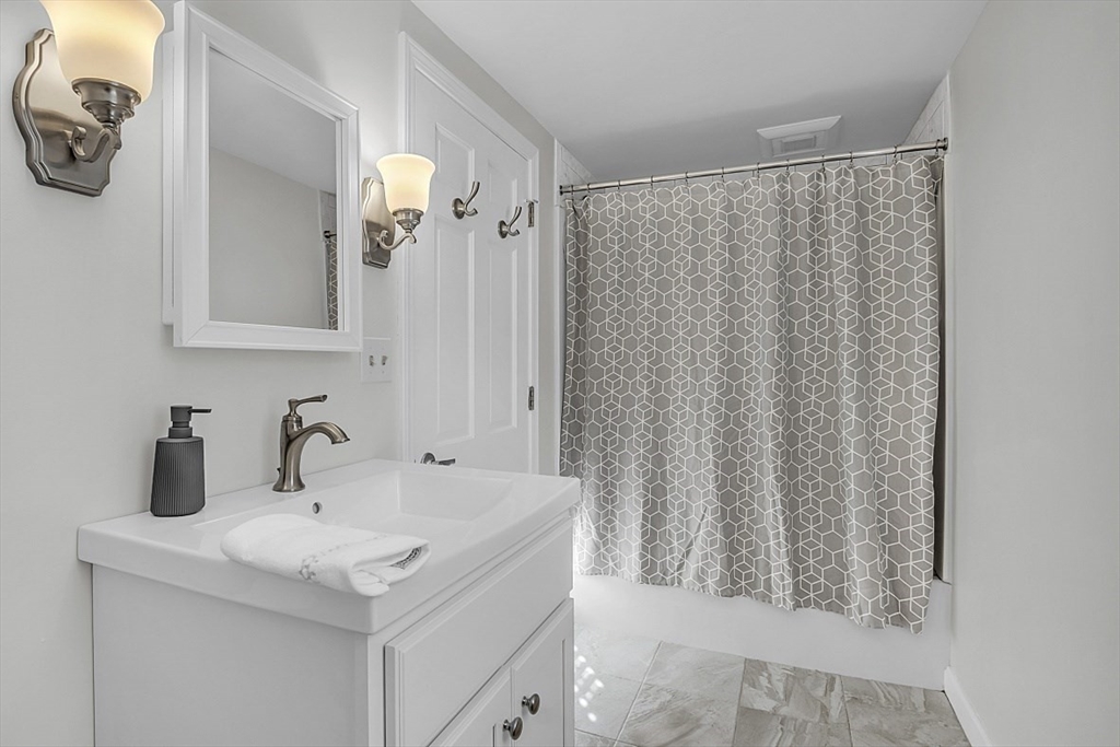 114 Bailey Road Andover, MA 01810 - Photo 28 of 42 a bathroom with a sink and a mirror