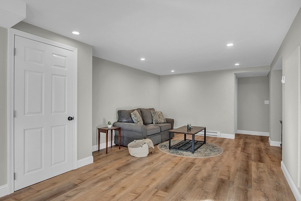 114 Bailey Road Andover, MA 01810 - Photo 31 of 42 a living room with furniture and a wooden floor