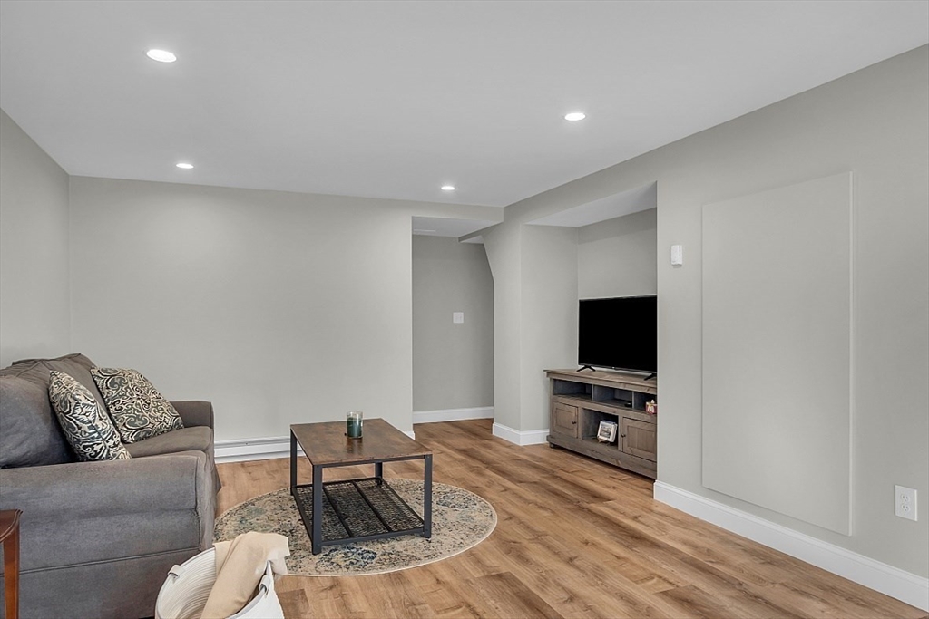 114 Bailey Road Andover, MA 01810 - Photo 32 of 42 a living room with furniture and a flat screen tv