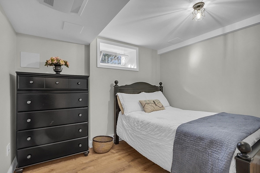 114 Bailey Road Andover, MA 01810 - Photo 36 of 42 a bedroom with a bed and a chandelier