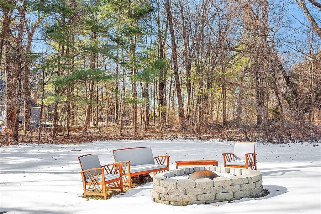 114 Bailey Road Andover, MA 01810 - Photo 40 of 42 a backyard of a house with large trees and outdoor seating