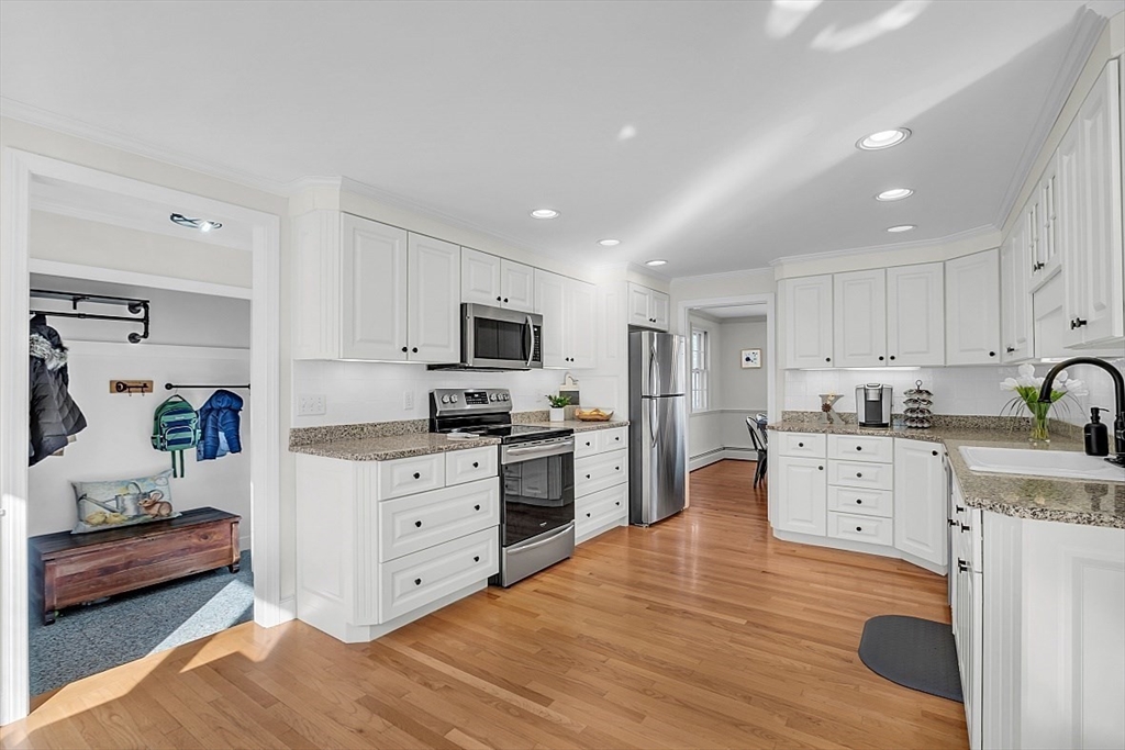 114 Bailey Road Andover, MA 01810 - Photo 8 of 42 a large white kitchen with stainless steel appliances granite countertop a stove and a sink