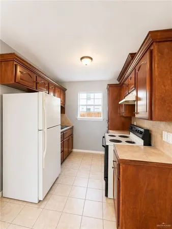 a kitchen with stainless steel appliances a refrigerator and a stove top oven