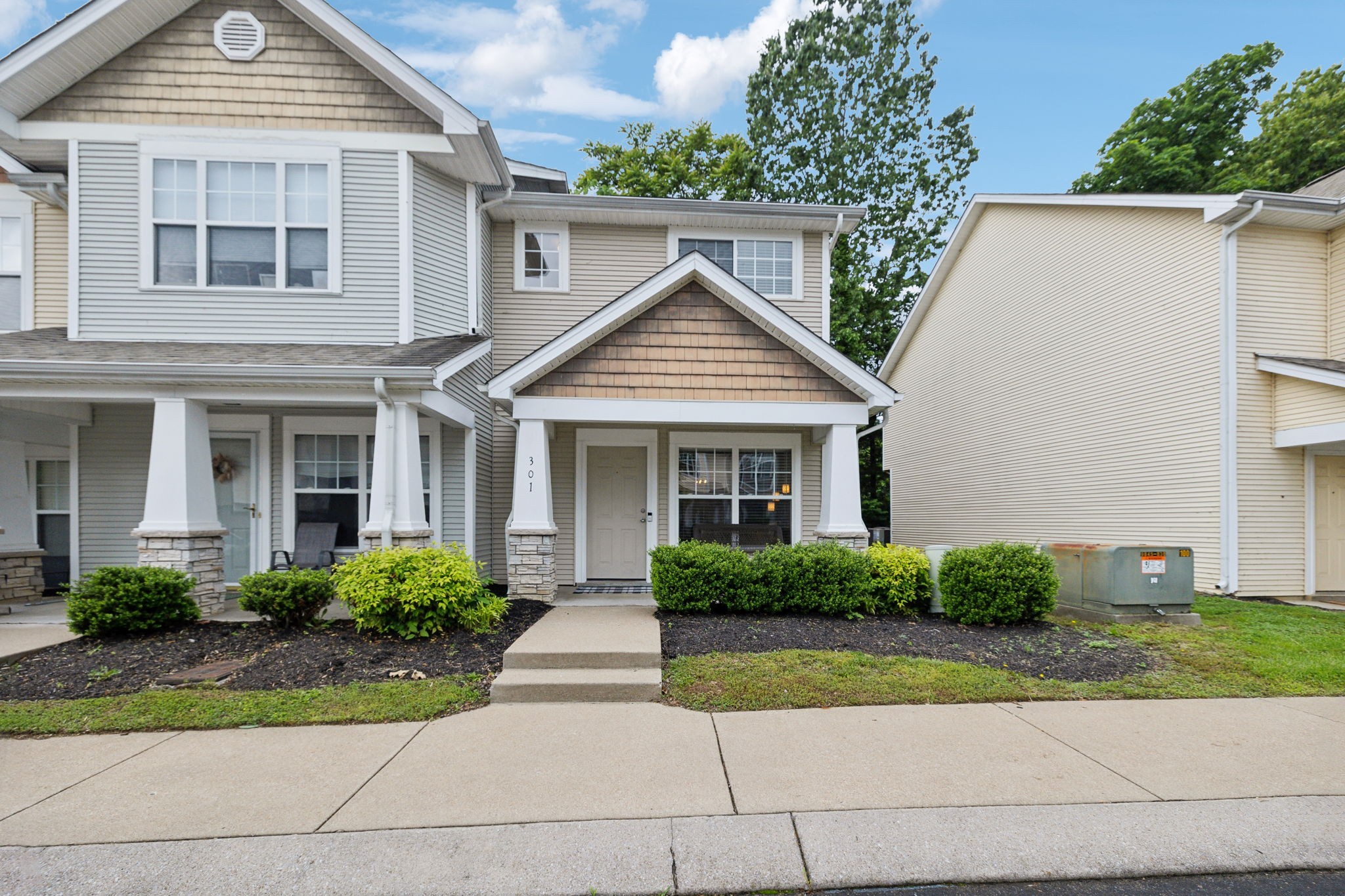 3535 Bell Road, Unit 301 Nashville, TN 37214 - Photo 2 of 47 a front view of a house with a yard and potted plants