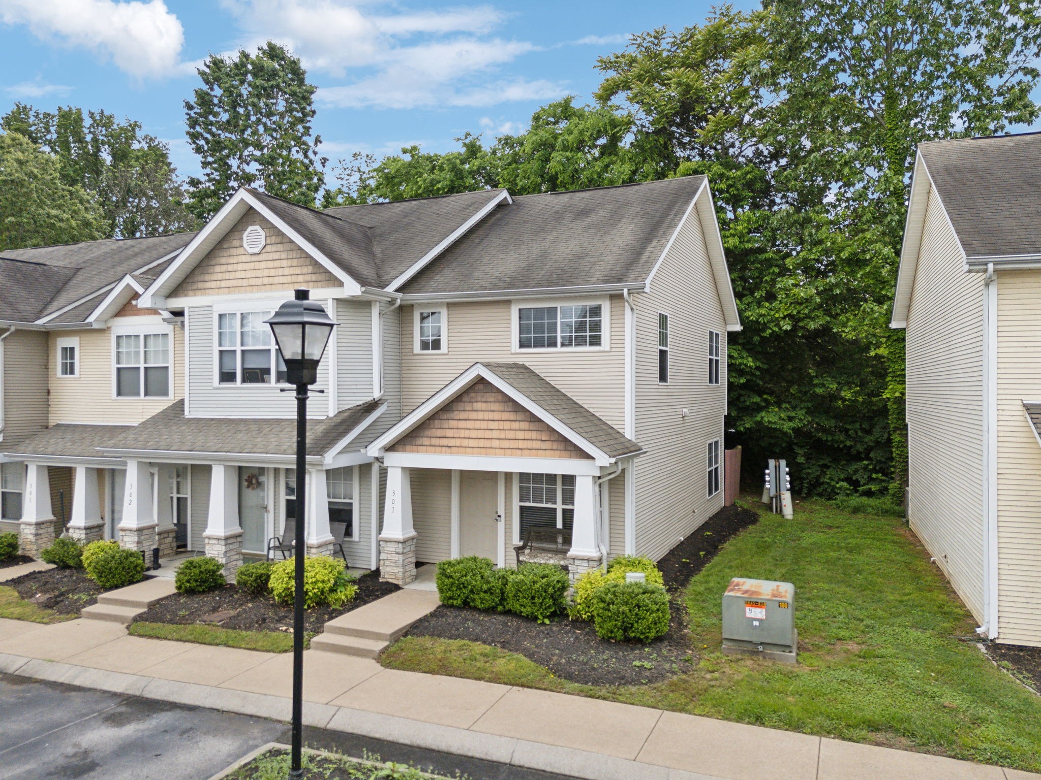 3535 Bell Road, Unit 301 Nashville, TN 37214 - Photo 3 of 47 a front view of a house with a yard and potted plants